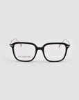 The Claudia by For Art's Sake® features black rectangular frames with clear lenses, combining thick acetate fronts and slender metal temples in the brand’s signature style, shown against a plain white background.