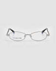 The Iris opticals by For Art's Sake® feature silver geometric frames, clear lenses, and black temple tips, shown on a light grey background. "FOR ART'S SAKE" is etched on the left lens, capturing quiet luxury.