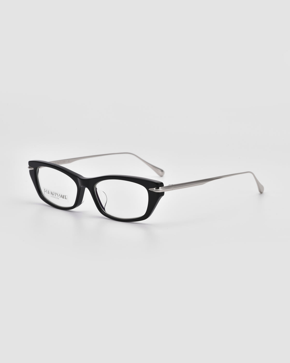 Suri I by For Art’s Sake®: Black-rimmed rectangular optical frames with silver metal temple accents and an acetate silhouette, shown against a plain white background.