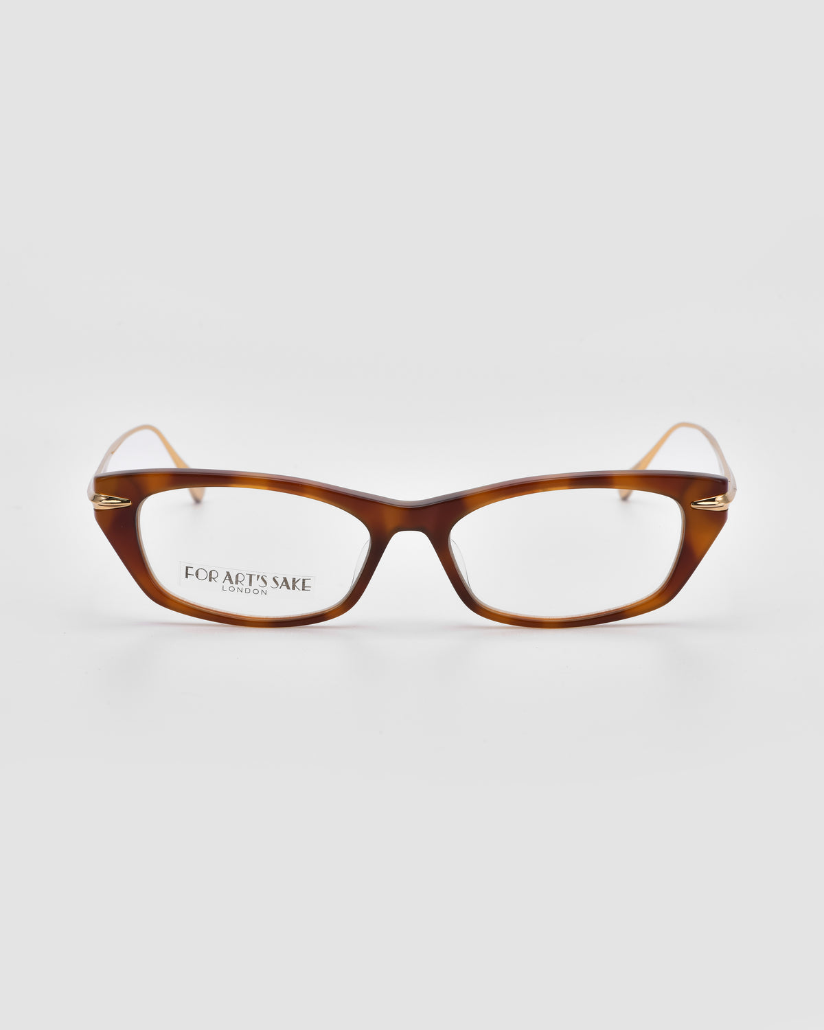 Suri I rectangular optical frames by For Art’s Sake® in brown tortoiseshell with thin gold metal temples are shown on a white background. “FOR ART’S SAKE” subtly appears on the left lens.