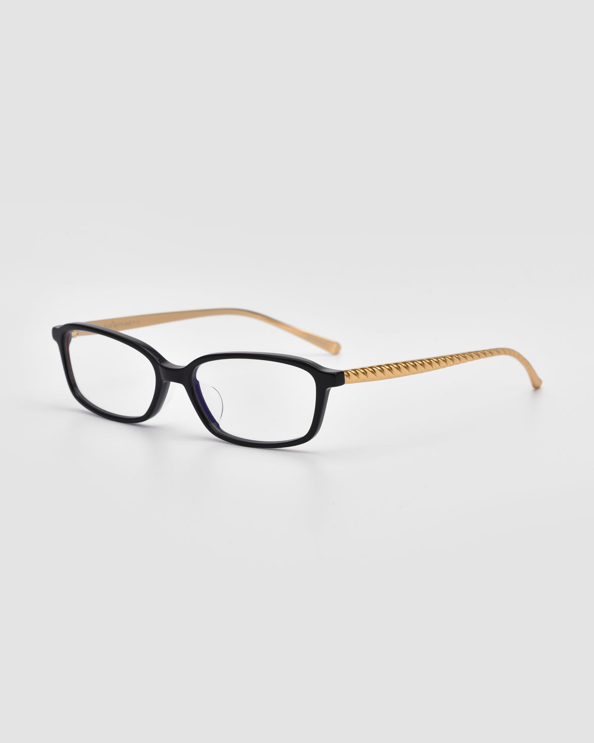For Art’s Sake® Lumi I: Black-rimmed optical frames with rectangular lenses and metal temples, featuring light brown zigzag-patterned arms—statement eyewear on a plain white background.