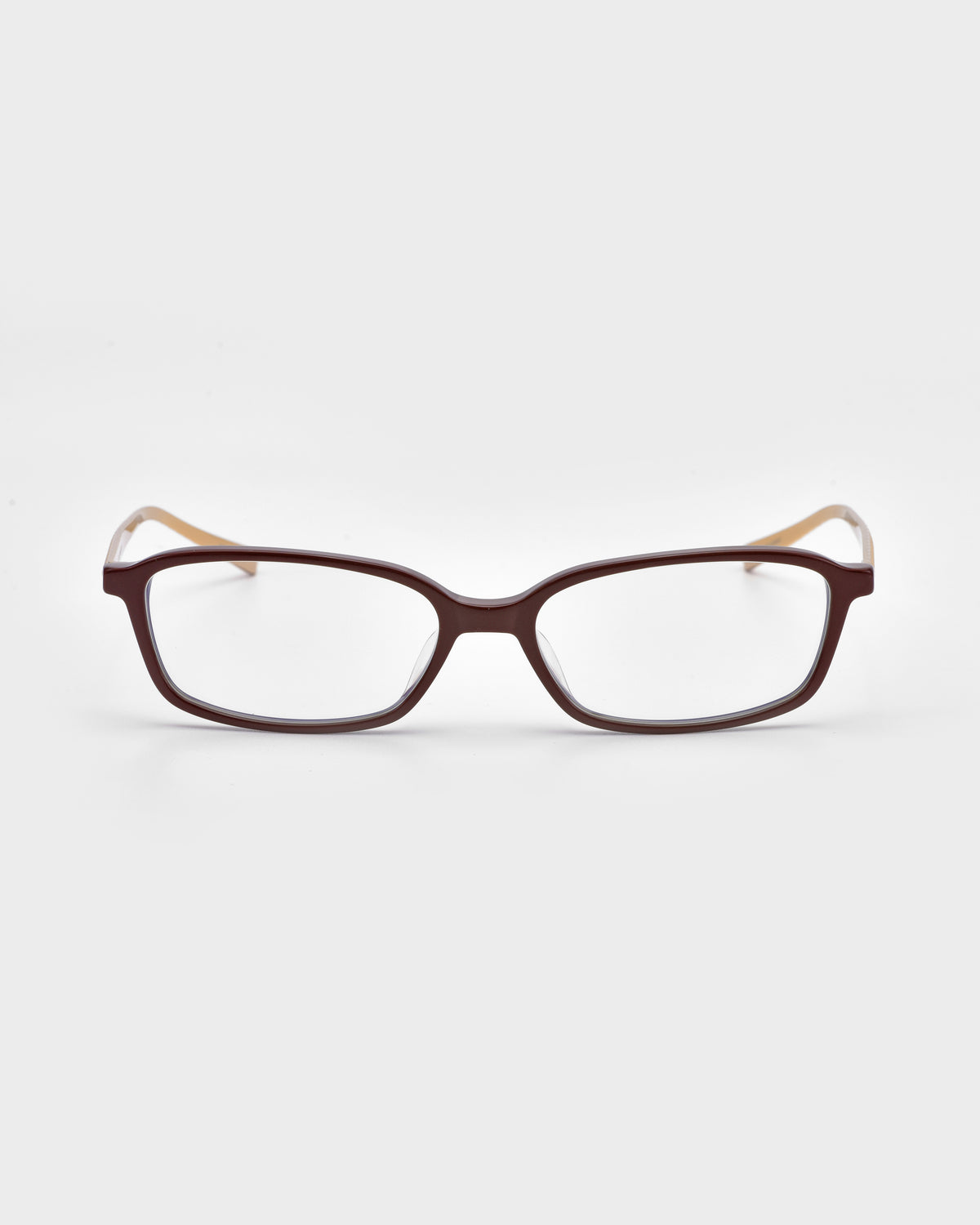 The Lumi I by For Art’s Sake® features rectangular optical frames with dark brown fronts and bold, light metal temples, shown against a white background.