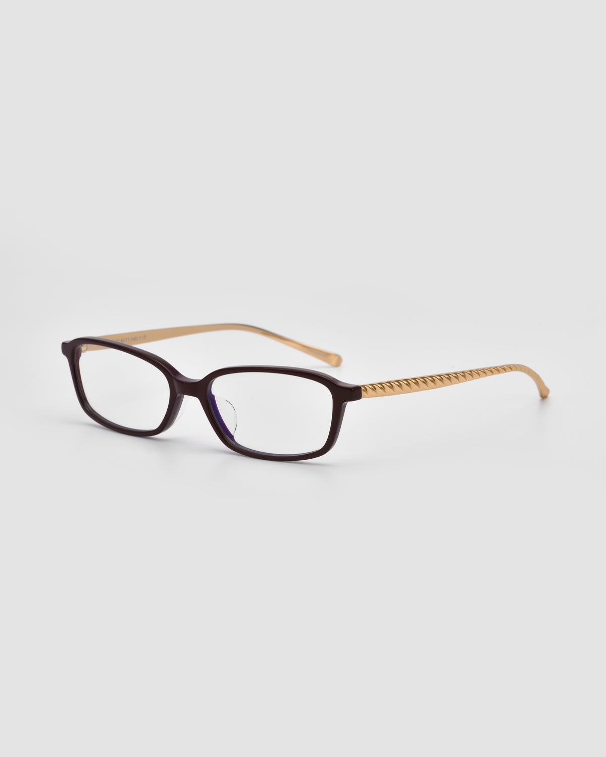 For Art’s Sake® Lumi I: Black rectangular optical frames with light brown, textured arms and sleek metal temples, shown angled on a plain white background highlighting the front and side details.