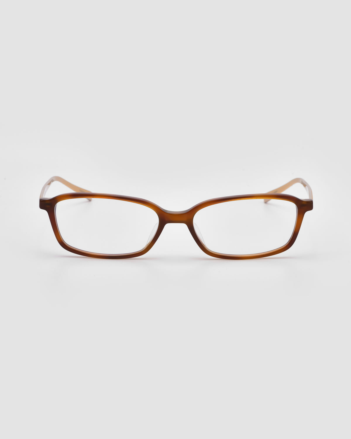 The Lumi I by For Art’s Sake® features brown rectangular optical frames with clear lenses and metal temples, offering a lightweight, classic design perfect for statement eyewear.