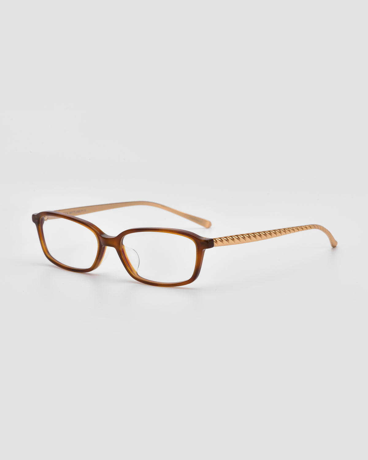 Lumi I by For Art’s Sake®: brown rectangular optical frames with clear lenses, patterned arms, and sleek metal temples, shown on a light gray background.