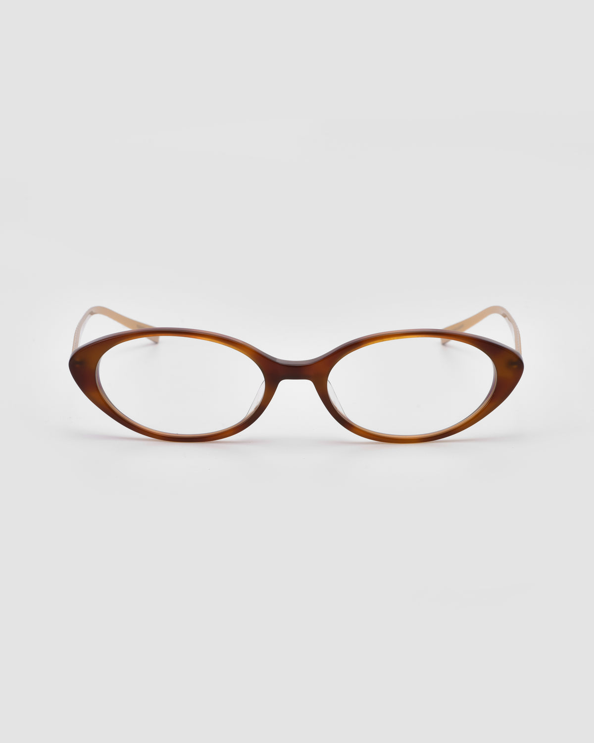 Lumi II by For Art’s Sake®—brown cat-eye acetate glasses with clear lenses, shown on a plain white background, facing forward. Bold, statement eyewear.