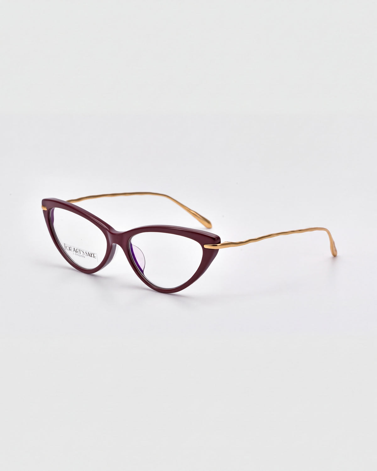 Solange by For Art’s Sake®: purple cat-eye opticals with sculpted metal temples, shown on a white background.