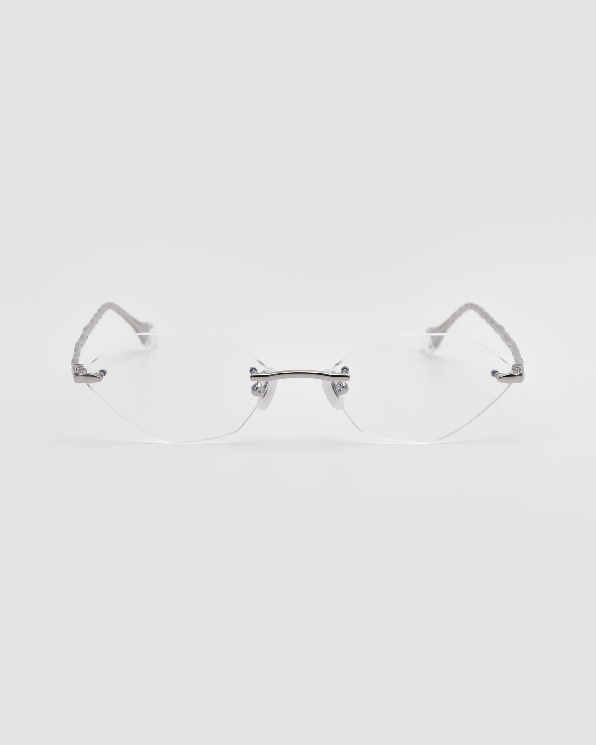 Amara I rimless eyeglasses by For Art’s Sake®, featuring clear lenses, thin silver metal temples, and sculpted nylon temple tips, displayed on a plain white background.