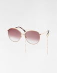 Yoyo - ARC by For Art's Sake® are round, handmade sunglasses with 18-karat gold-plated frames and gradient brown lenses, featuring decorative pearl chains attached to the temples, set against a plain white background.