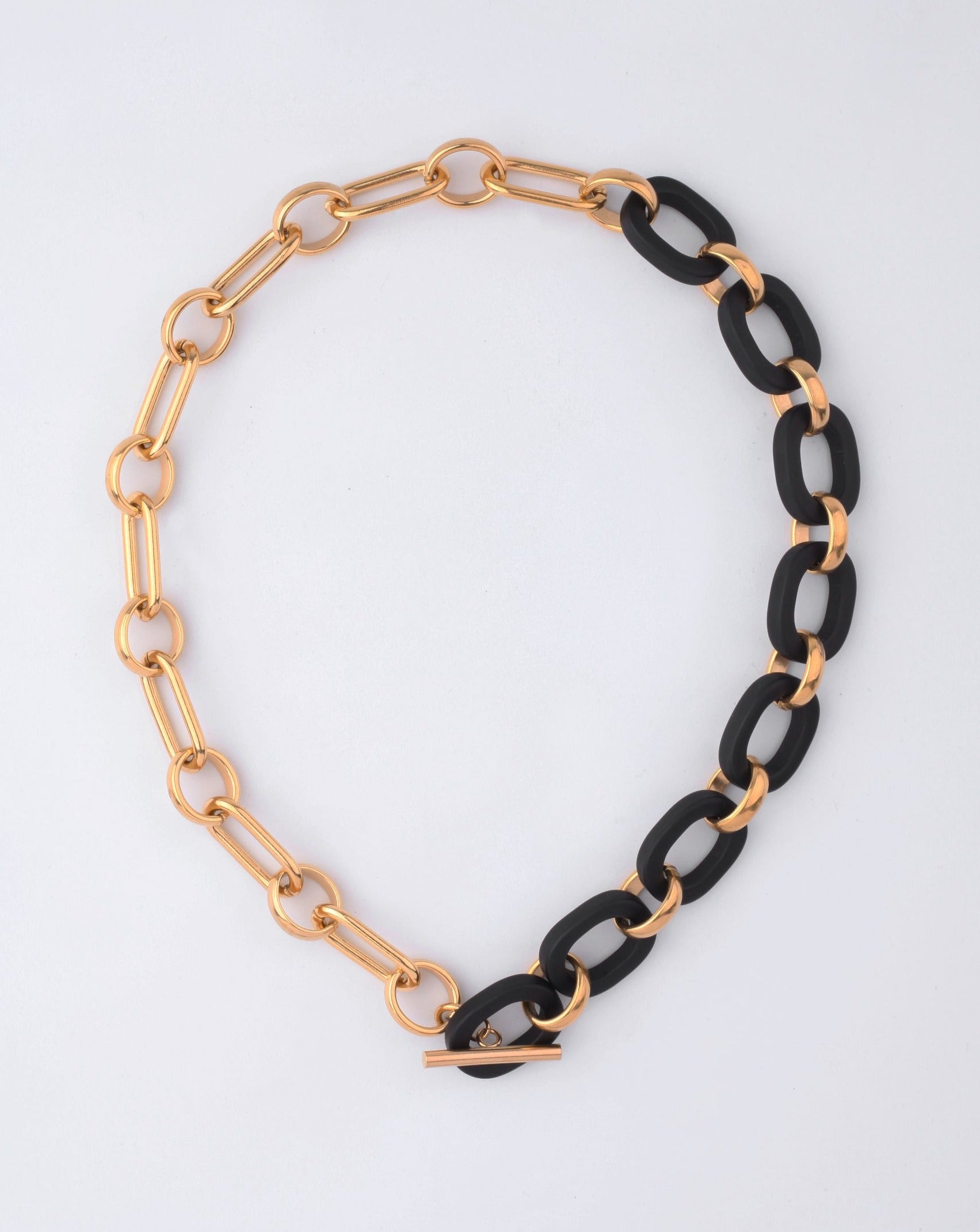 The For Art's Sake® Bexley Necklace showcases chunky resin with alternating large gold and black 18-karat gold-plated links, finished with a toggle clasp and displayed on a plain white background.