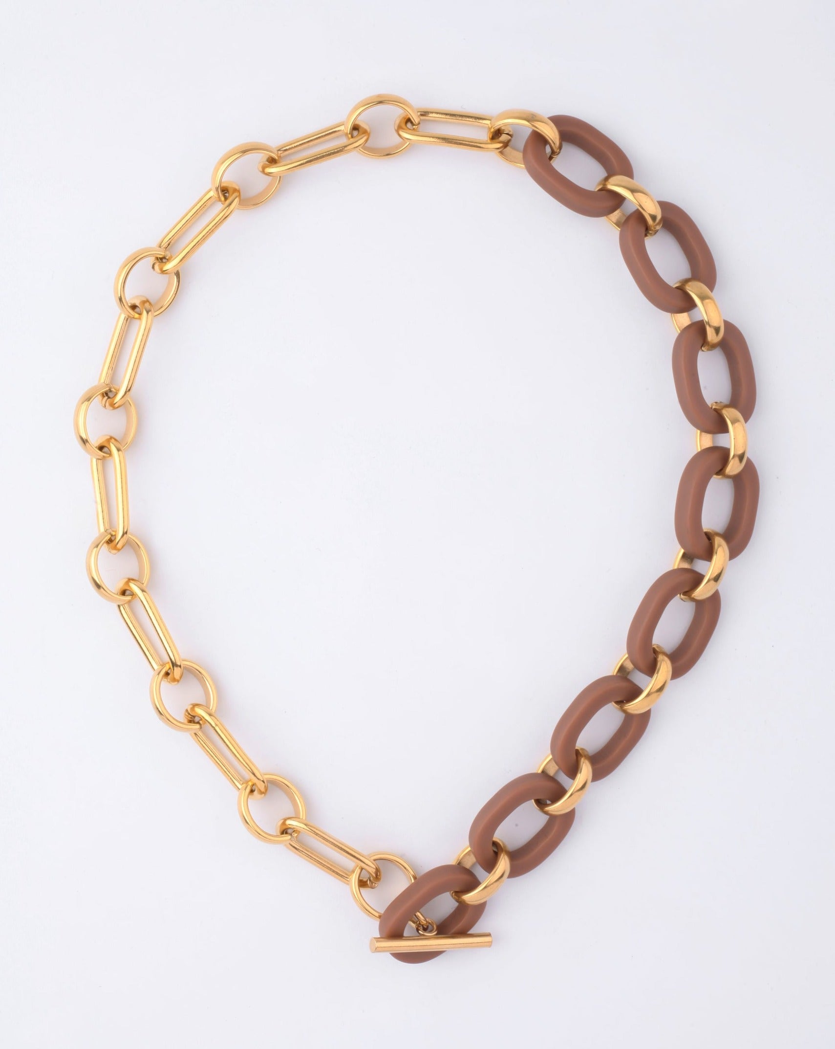 The Bexley Necklace by For Art's Sake® features chunky matte brown resin links, alternating with 18k gold-plated ovals and finished with a gold T-bar clasp, shown on a plain white background.