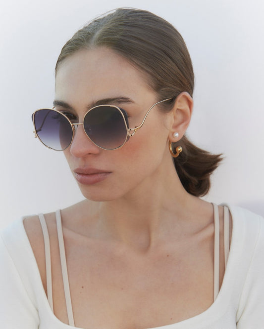 Woman with short brown hair wearing the Canvas Sunglasses in Black